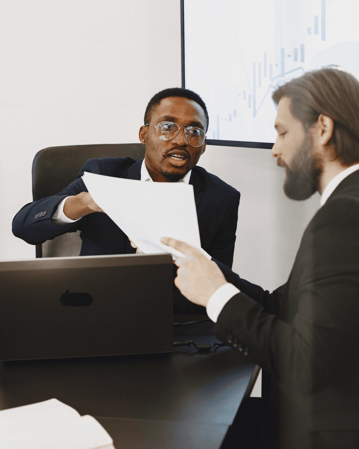 Two colleagues reviewing a signed agreement in a meeting